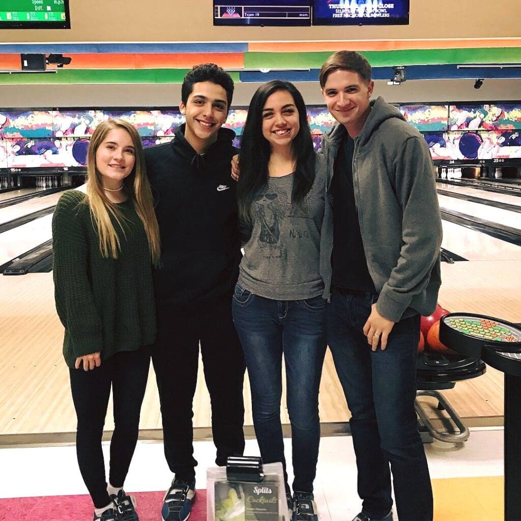 Friends smiling on the lanes at Rowlett Bowl-A-Rama