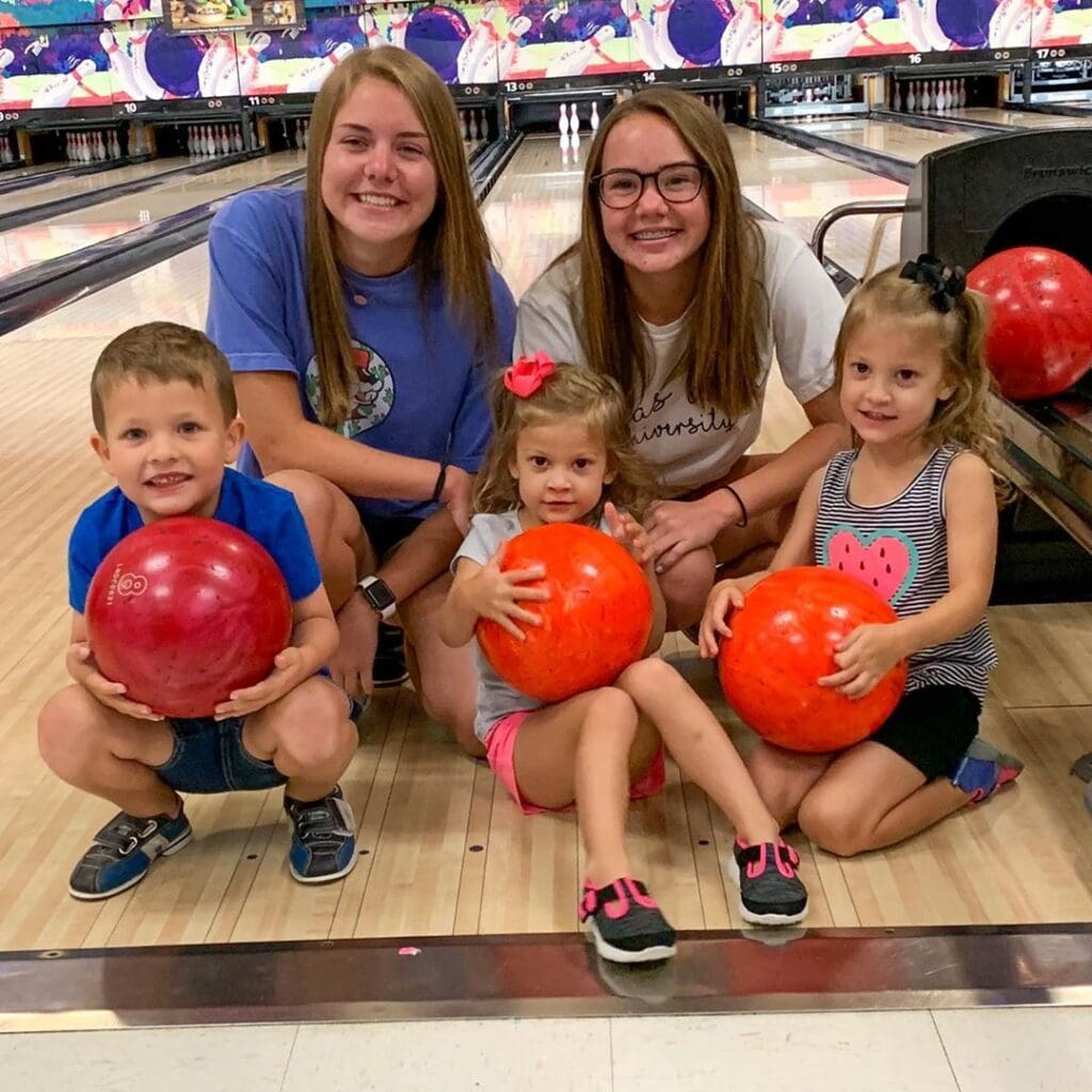 Young bowlers with their bowling balls at Rowlett Bowl-A-Rama