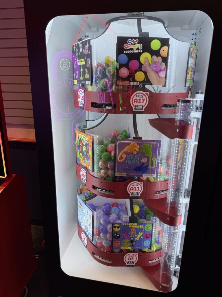 Arcade prize machine stocked with toys, games and candy