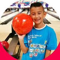 Young bowler holding a bowling ball at Rowlett Bowl-A-Rama